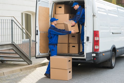 Professional movers loading furniture into a van
