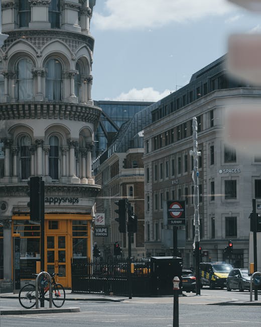 Close-up view of the exterior of a building on Clapham High Street during a house removal process, showing a white sign with black and red lettering indicating the address 'HIGH HOLBORN WC1' affixed t